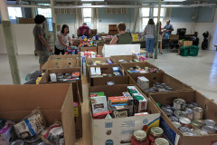 FCCMP staff sorting and creating grocery bags of food