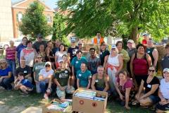 A happy and tired group of volunteers reflect on a job well done at the 15th annual Fill The Belly Bus food drive!