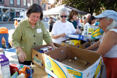 Sen. Jo Comerford, left, sorts through food donations with volunteers during the 15th annual Fill the Belly Bus Community Food Drive on Friday afternoon at the Greenfield Common.