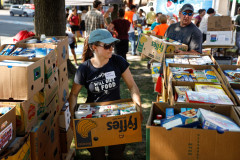 Volunteers sort through food donations during the 15th annual Fill the Belly Bus Community Food Drive on Friday afternoon at the Greenfield Common.