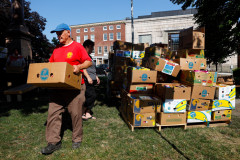 Volunteers sort through food donations during the 15th annual Fill the Belly Bus Community Food Drive on Friday afternoon at the Greenfield Common.