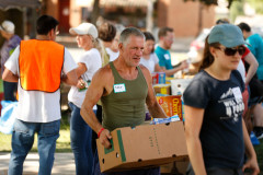 Volunteers sort through food donations during the 15th annual Fill the Belly Bus Community Food Drive on Friday afternoon at the Greenfield Common.