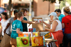 Volunteers sort through food donations during the 15th annual Fill the Belly Bus Community Food Drive on Friday afternoon at the Greenfield Common.