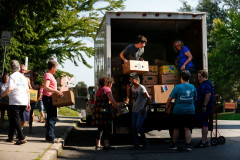 Volunteers pack up food donations for transport during the 15th annual Fill the Belly Bus Community Food Drive on Friday afternoon at the Greenfield Common.