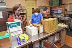 FCCMP Executive Director Rachel Berggren and Joanne McGee of the Trinitarian Congregational Church of Northfield with supplies for the new meal site at the Northfield Church.